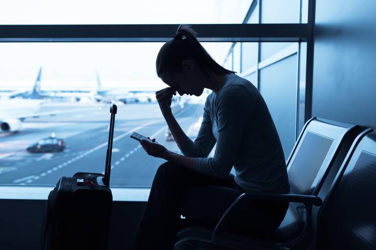 airport-woman-checking-her-phone