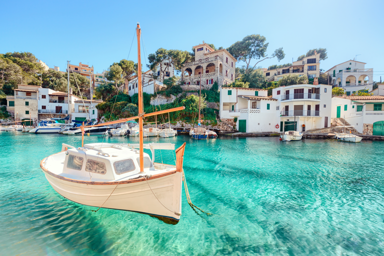 europe-spain-mallorca-boat-in-water-with-houses-on-backdrop