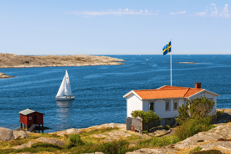 europe-sweden-lake-red-house-boat-swedish-flag