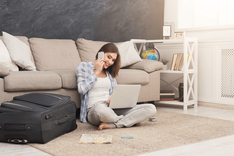 general-woman-smiling-packing-paying-laptop-travel