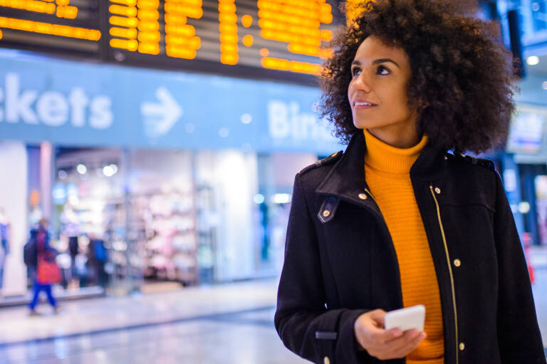 general-woman-traveling-airport-turtleneck-phone