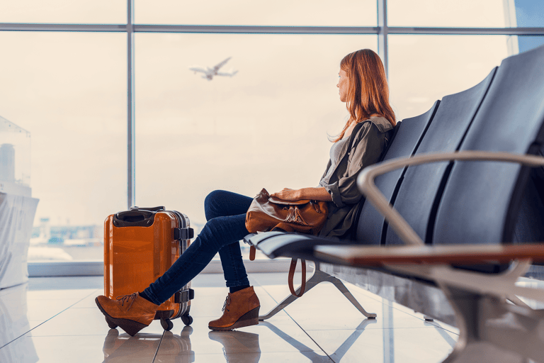 general-woman-waiting-at-gate-suitcase