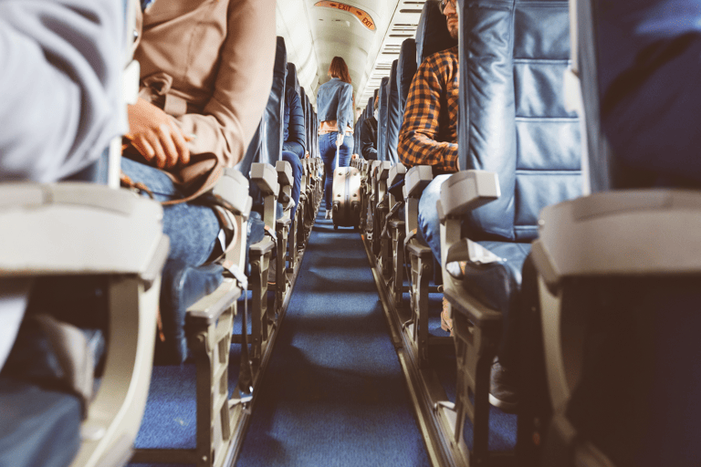 generic-airplane-boarding-passengers-woman-walking-down-aisle