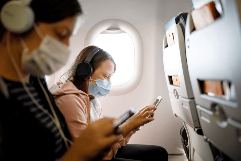 generic-airplane-onboard-kids-face-mask-looking-cellphone-mobile