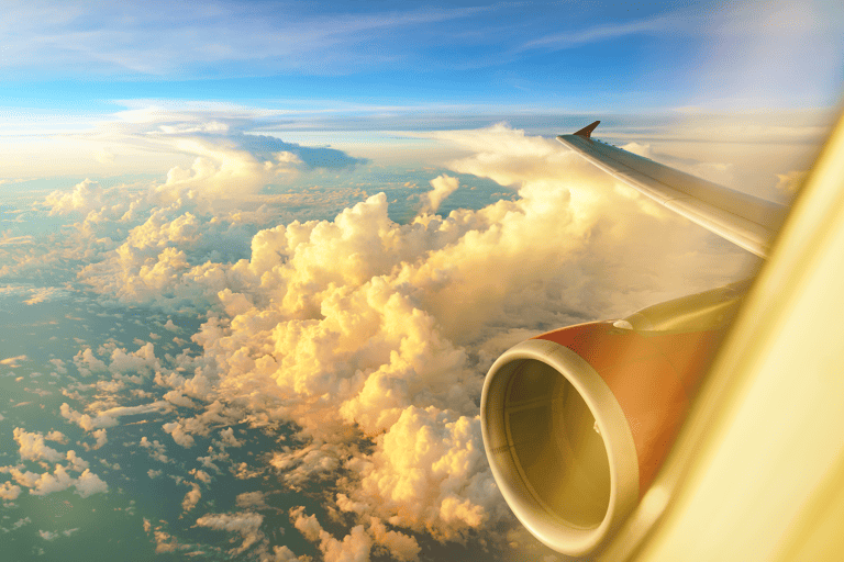 generic-airplane-window-view-sunset-blue-sky