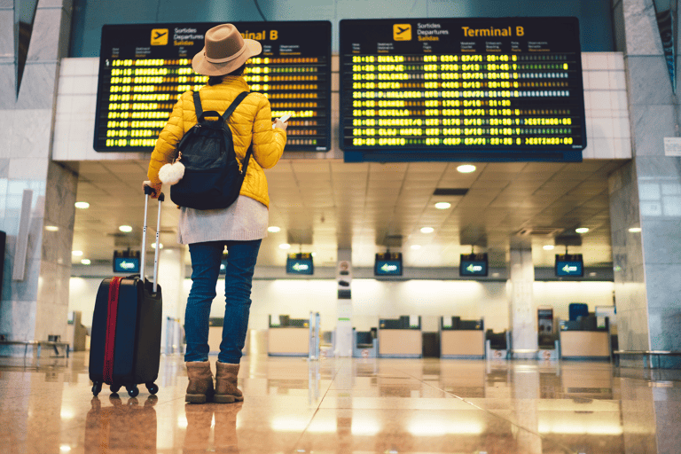 generic-airport-woman-before-departure-board