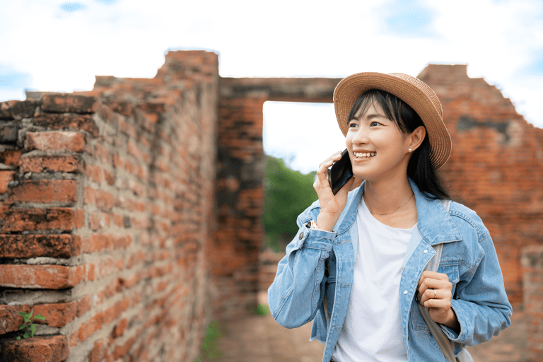 generic-asian-female-talking-on-phone-while-sightseeing-travel