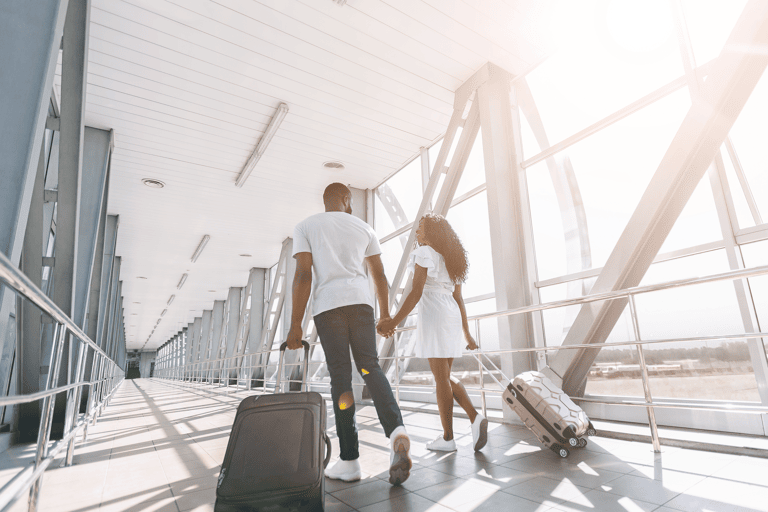 generic-couple-walking-with-suitcases-in-airport