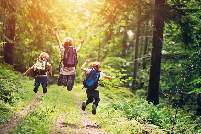 generic-kids-hiking-forest-jumping-happy