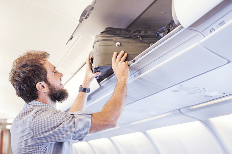 generic-man-puts-luggage-airplane