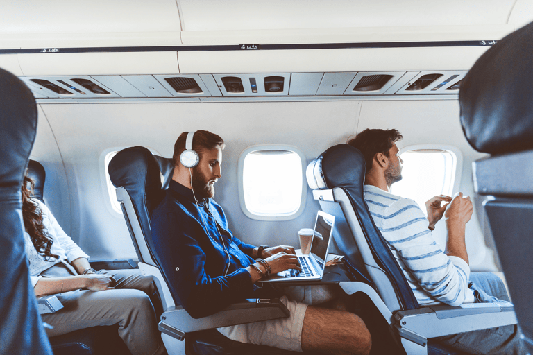 generic-passengers-in-airplane-man-with-laptop-and-headphones
