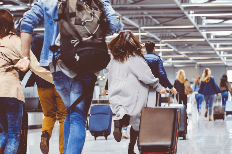 generic-passengers-rushing-airport-with-luggage