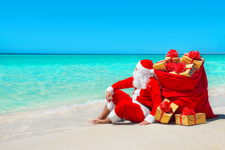 generic-santa-claus-resting-beach-ocean-bag-wrapped-gifts