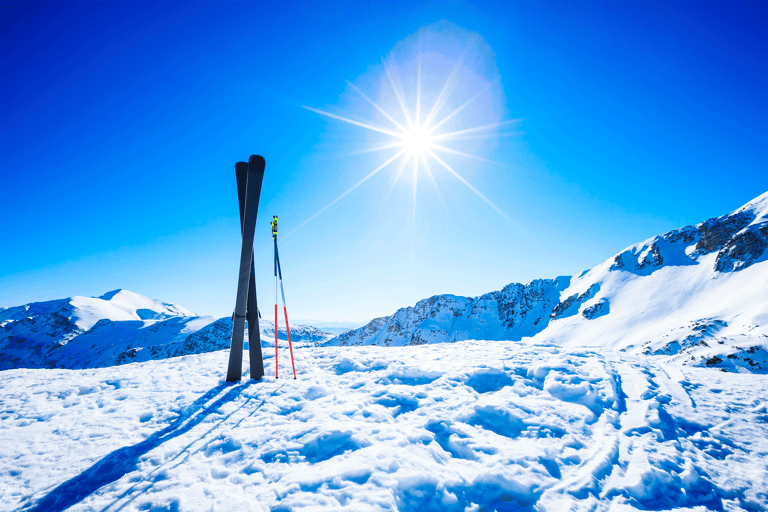generic-snow-mountain-skis-poles-sun-blue-sky
