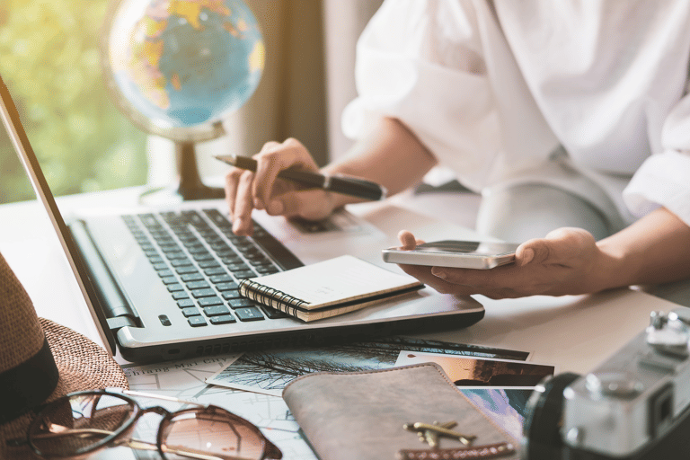 generic-travellers-planning-a-trip-and-searching-on-laptop