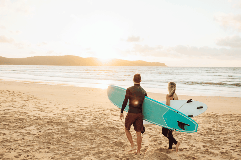 generic-two-surfers-surfboards-walking-beach