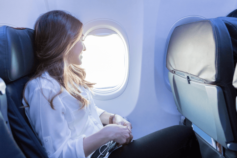 generic-woman-in-airplane-looking-window