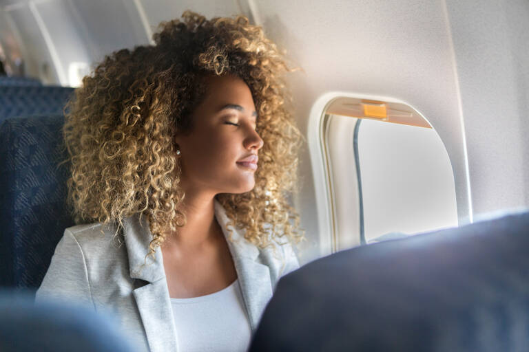 generic-woman-sitting-window-aisle-seat