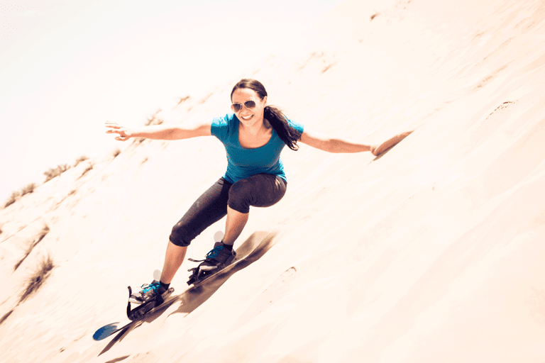 middle-east-united-arab-emirates-dubai-female-sandboarding-happy