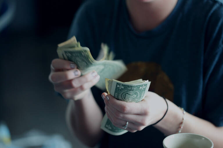 woman-counting-us-dollar-notes-money